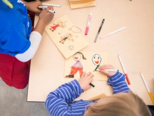 Children create artwork at a table