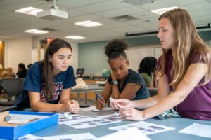 Camp participants complete a hands-on STEM activity in a workspace on campus